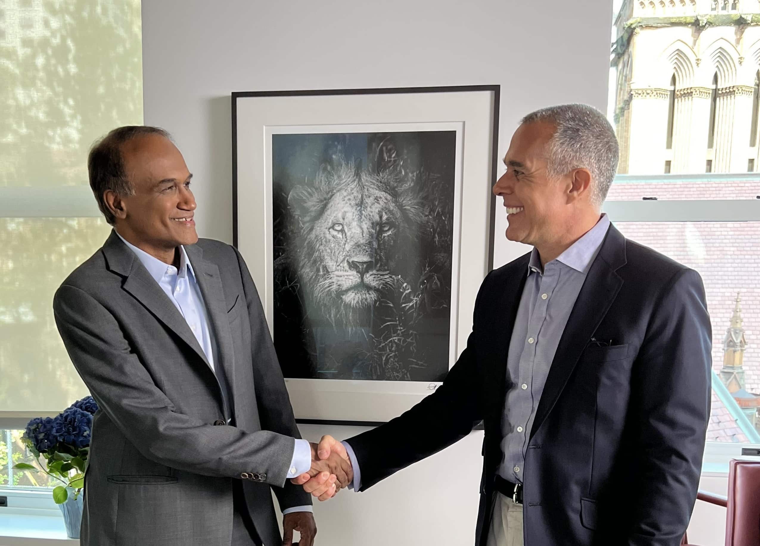 Business professionals shaking hands in office meeting
