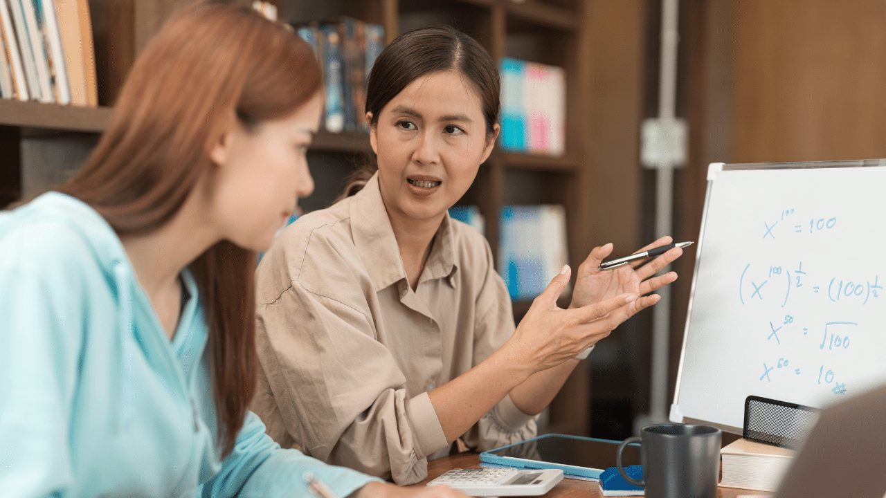 Woman discussing How Test Prep Shapes project with colleagues in office.