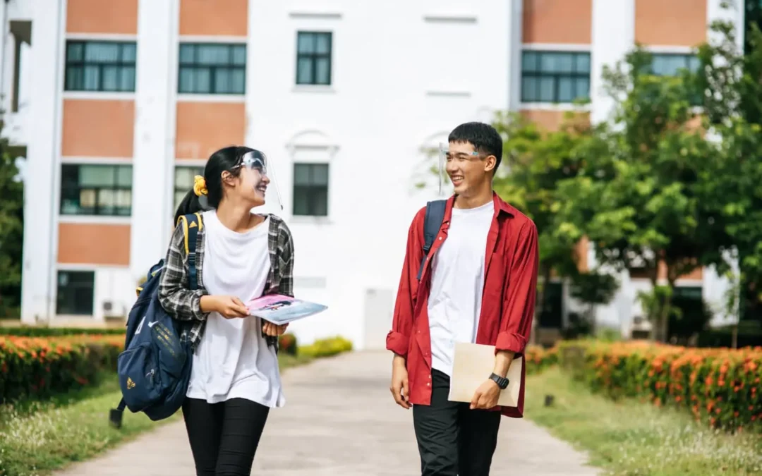 two students coming out of school and laughing