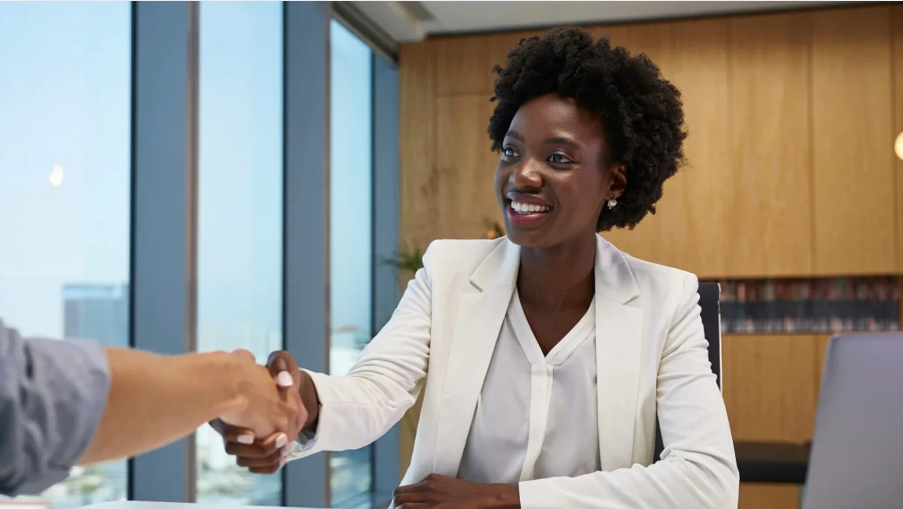 College applicant shaking hands with admissions officer.