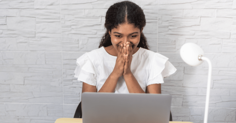 A high school student reviewing their college waitlist decision letter at a desk.