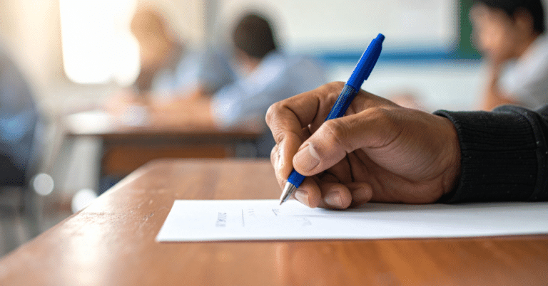 A high school student comparing SAT vs ACT study materials on a desk.