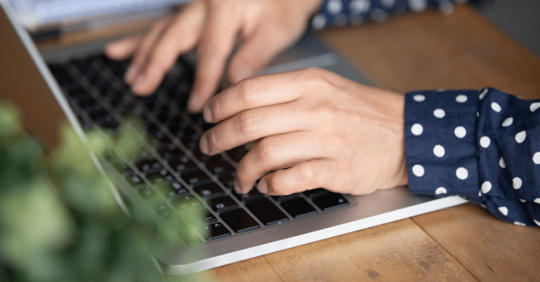 student writing common app essay and reviewing essay prompts